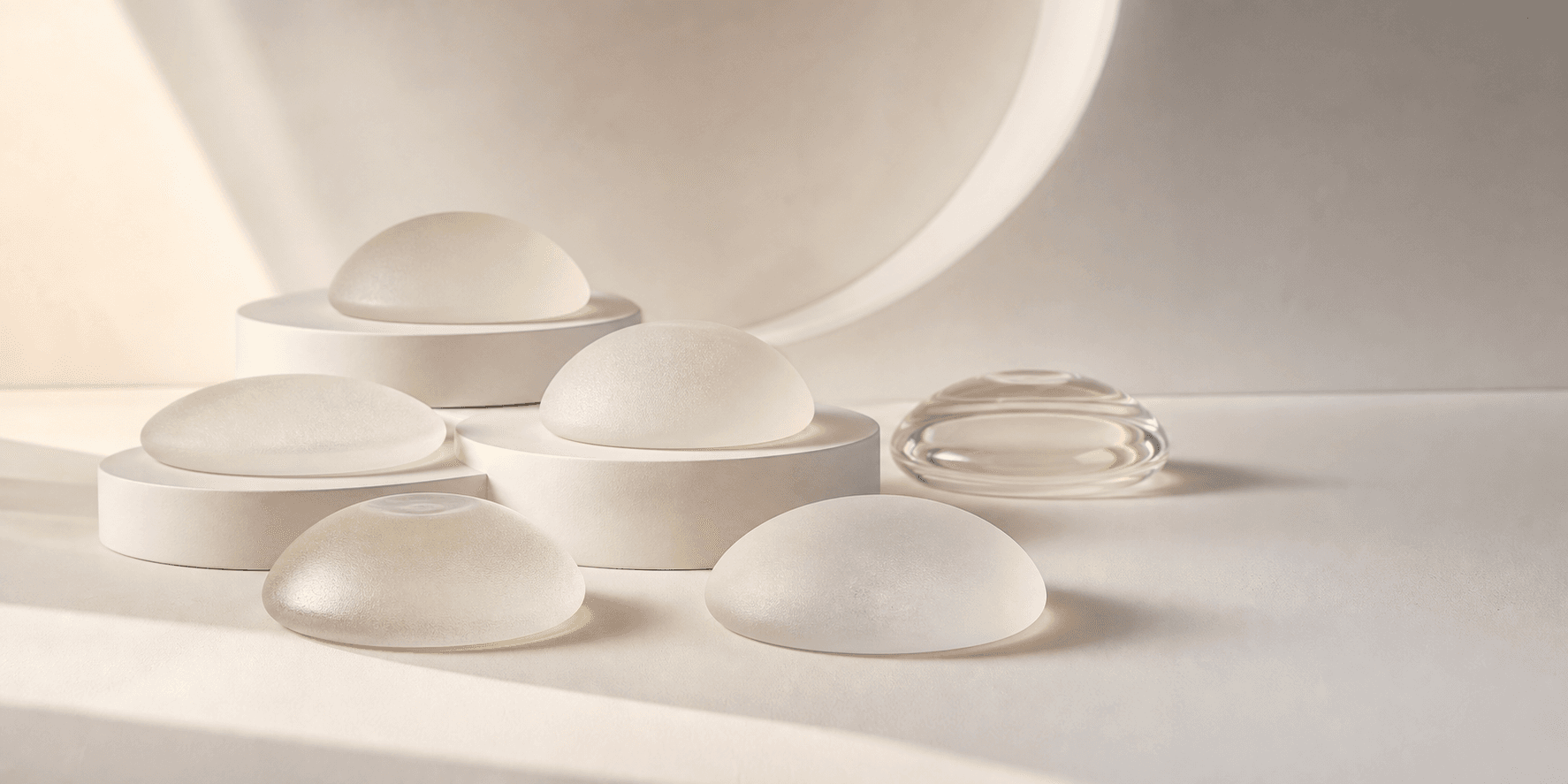 Abstract forms illustrating differences in breast implant width, profile, fill, and surface