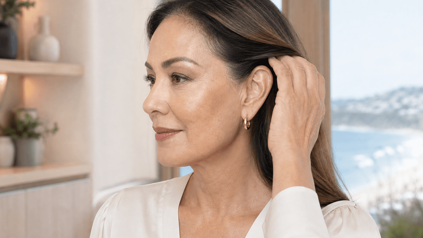 Woman tucking back her hair to view facelift incision areas around the ear