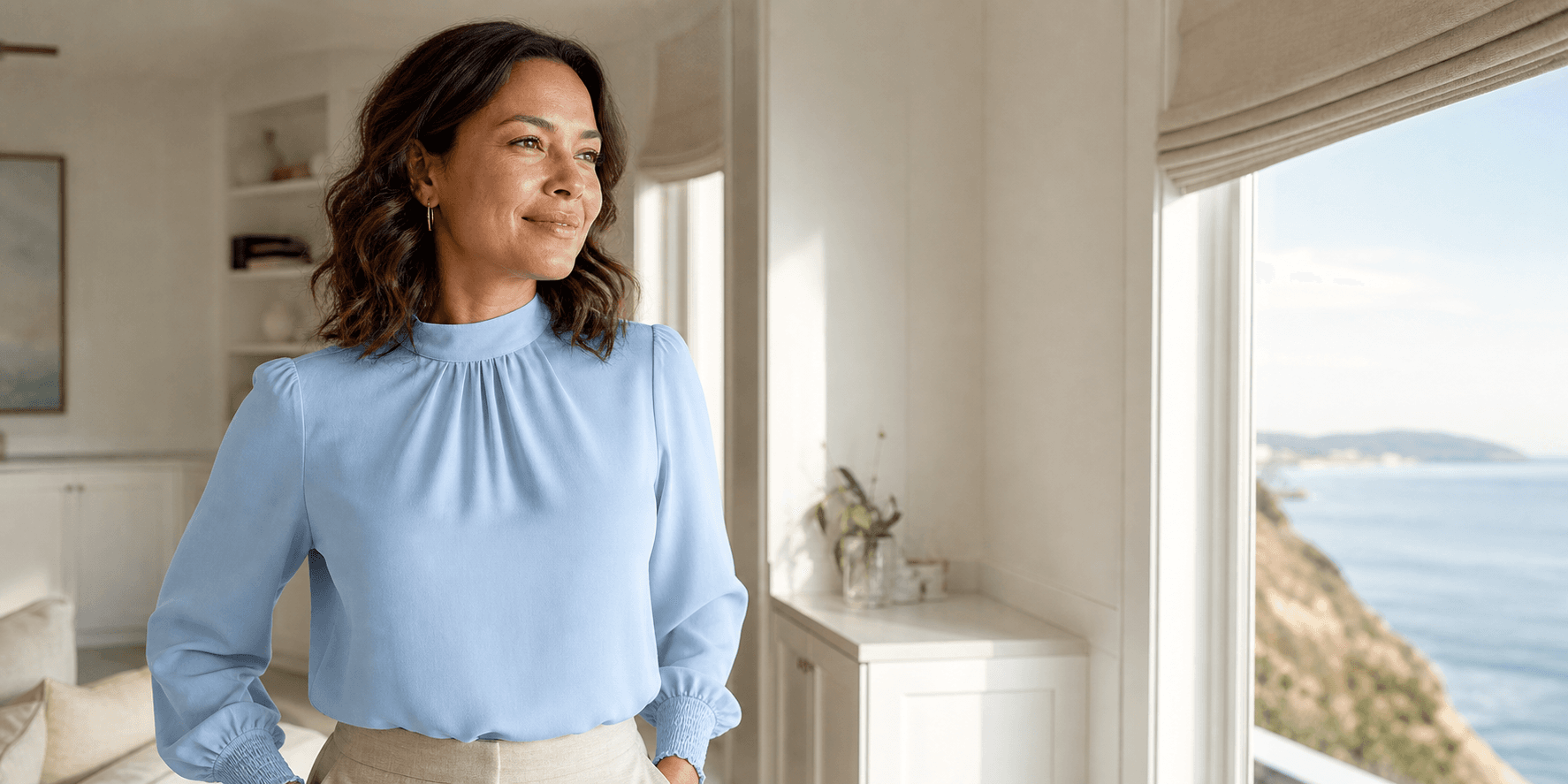 Woman standing comfortably in a modest blue blouse after considering breast reduction